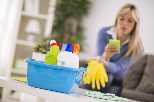 Cleaner wearing protective gloves and footwear during carpet cleaning